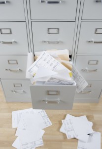 File Cabinet Overflowing with Paperwork